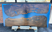 Live edge wood with epoxy resin dining table in modern home
