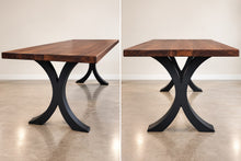 Eclipse double pedestal black metal dining table base with sculptural curved supports for rectangular wood tabletops.