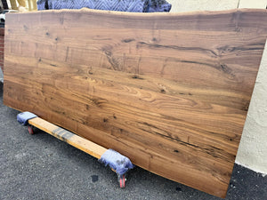Live edge walnut wood table top measuring 93x39 inches with natural grain and rich brown tones
