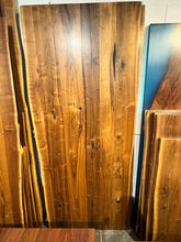 Live edge walnut wood slab dining table top with rich grain patterns and natural edges, ideal for custom furniture and luxury interior design.