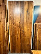 Live edge walnut wood slab dining table top with rich grain patterns and natural edges, ideal for custom furniture and luxury interior design.