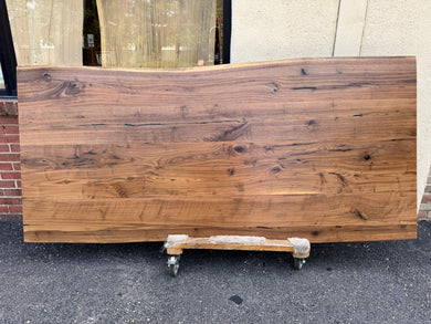 Live edge walnut wood slab dining table top with rich grain patterns and natural edges, ideal for custom furniture and luxury interior design.