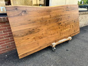 Live edge walnut wood slab dining table top with rich grain patterns and natural edges, ideal for custom furniture and luxury interior design.