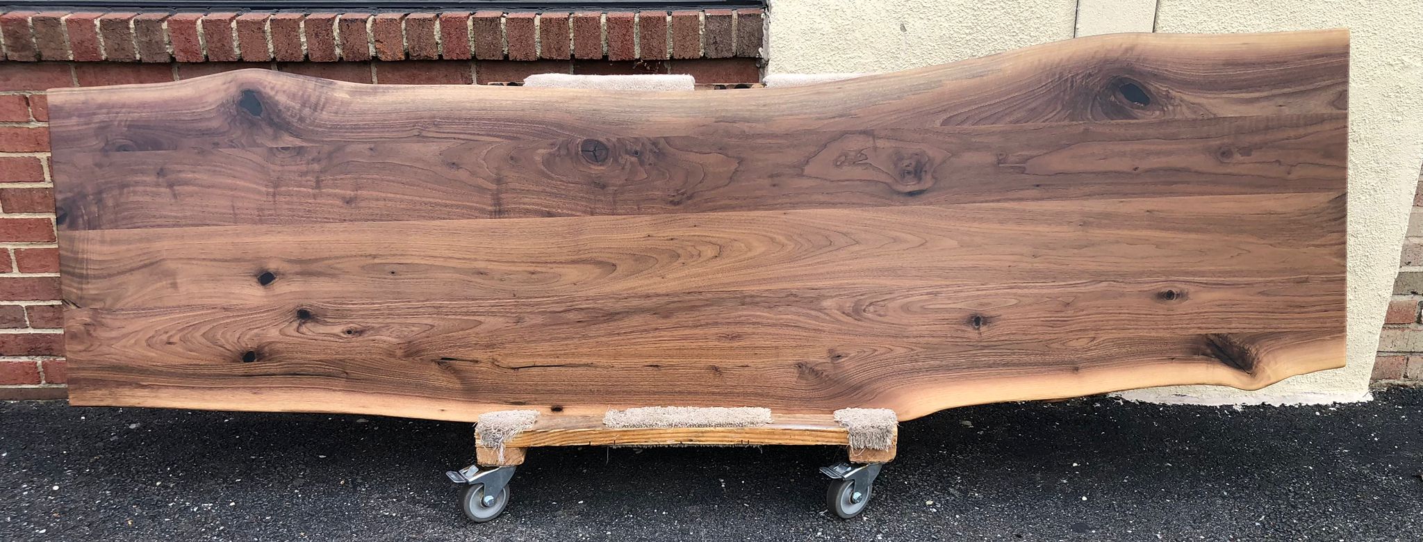Live edge walnut wood lounge tabletop featuring rich brown tones, natural grain patterns, and organic edges, perfect for rustic or modern custom furniture design.