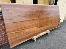 Handcrafted live edge wood dining table made from solid walnut, featuring natural wood grain and rustic modern design – perfect for farmhouse or contemporary dining rooms.