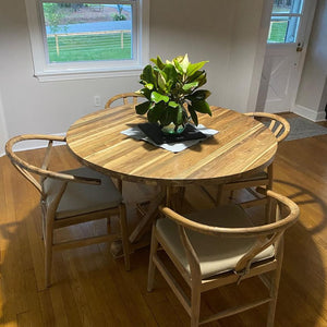 Reclaimed teak wood round dining table with wishbone chairs