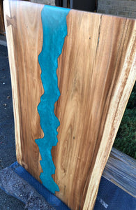 Live edge wood slab dining table with epoxy