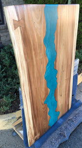 Live edge wood slab dining table with epoxy